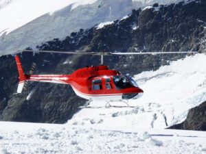 Jungfrau, Switzerlan. Red helicopter on high mountain snow - MyVideoimage.com