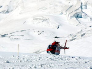 Jungfrau, Switzerlan. Red helicopter on high mountain snow - MyVideoimage.com