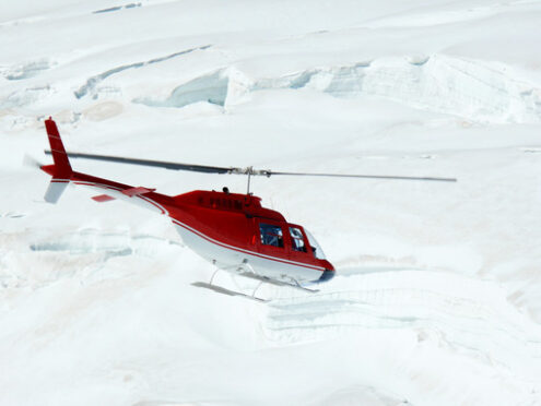 Jungfrau, Switzerlan.  Red helicopter on high mountain snow - MyVideoimage.com