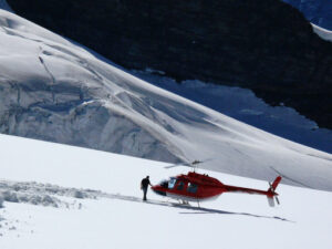 Jungfrau, Switzerland. 08/06/2009. Red colored helicopter and ma - MyVideoimage.com