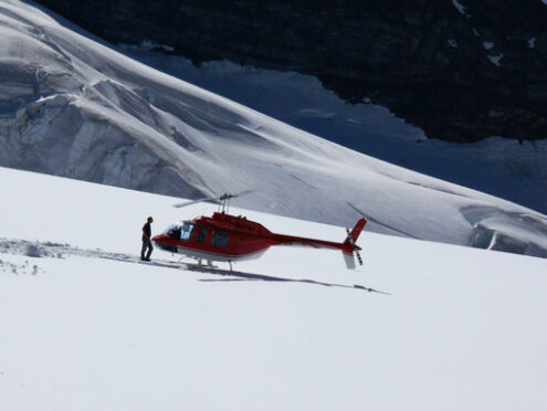 Jungfrau, Switzerland. 08/06/2009. Red colored helicopter and ma - MyVideoimage.com