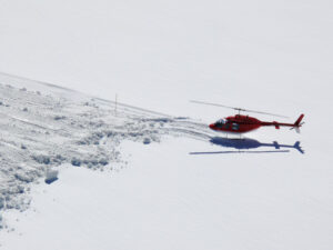 Jungfrau, Switzerland. Red helicopter on high mountain snow - MyVideoimage.com