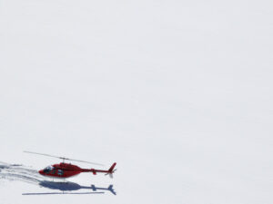 Jungfrau, Switzerland. Red helicopter on high mountain snow - MyVideoimage.com