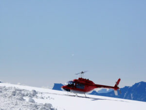 Jungfrau, Switzerland. Red helicopter on high mountain snow - MyVideoimage.com