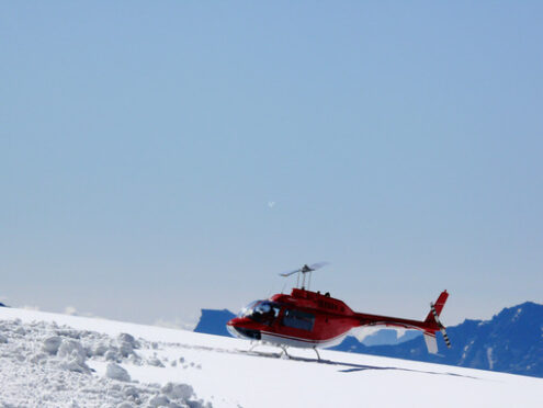 Jungfrau, Switzerland. Red helicopter on high mountain snow - MyVideoimage.com