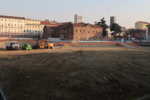 Large excavation. Construction site vehicles (trucks, excavators, bulldozers) in a large excavation for the construction of the new building of the Maggiore Policlinico hospital  in Milan. - MyVideoimage.com | Foto stock & Video footage