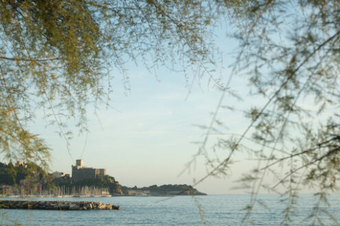 Lerici castle near the Cinque Terre illuminated by the light of the sunset. The fortress on the rock overlooking the blue sea - MyVideoimage.com | Foto stock & Video footage