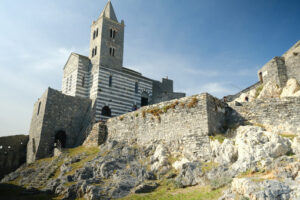 Ligurian villages: Portovenere. Church of San Pietro in Portovenere, near the Cinque Terre. Stairway with tourists. - MyVideoimage.com | Foto stock & Video footage