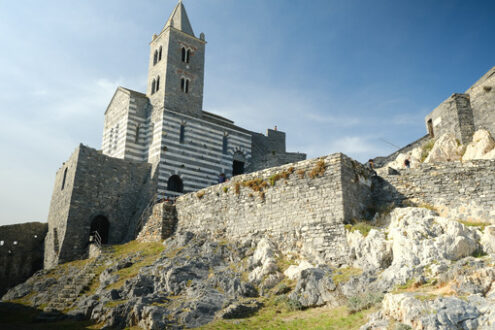 Ligurian villages: Portovenere. Church of San Pietro in Portovenere, near the Cinque Terre. Stairway with tourists. - MyVideoimage.com | Foto stock & Video footage