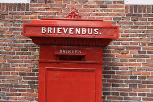 Mail box. Mailbox of red color against the background of red brick wall. - MyVideoimage.com | Foto stock & Video footage