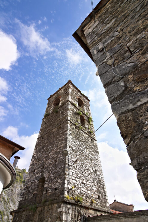 Marble bell tower. Colonnata. Bell tower of the church built with white marble pebbles. The ancient village, famous for its lard, is located in the heart of the Carrara marble quarries. Colonnata, Carrara, Tuscany, Italy. - MyVideoimage.com | Foto stock & Video footage