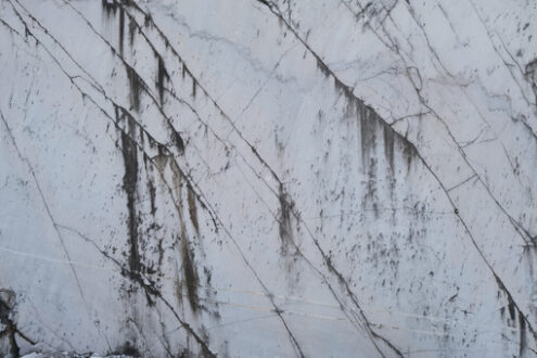 Marble texture. Carrara white marble wall. Rough natural marble surface in a quarry. Stock photos. - MyVideoimage.com | Foto stock & Video footage