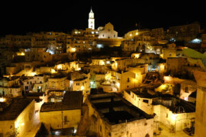 Matera di notte. Case in tufo. Night illumination of the ancient city of Matera. Houses made of blocks of tufa stone. - MyVideoimage.com | Foto stock & Video footage