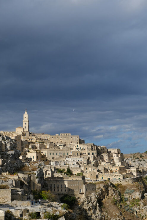 Matera panorama with sassi. Panorama of the Sassi of Matera with houses in tuff stone. Church and bell tower at dawn with sky and clouds. - MyVideoimage.com | Foto stock & Video footage