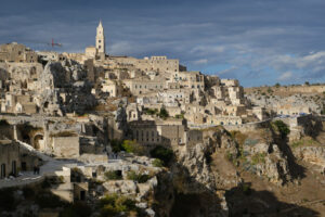 Matera panorama. Panorama of the Sassi of Matera with houses in tuff stone. Church and bell tower at dawn with sky and clouds. - MyVideoimage.com | Foto stock & Video footage