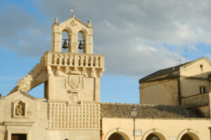 Materdomini Matera. Materdomini Church in Piazza Vittorio Veneto of Matera. Built flat bell tower with balustrade in beige tuff. - MyVideoimage.com | Foto stock & Video footage