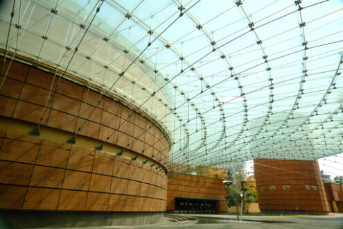 Modern architecture. Modern building with glass roof and brick facade. Stock photos. - MyVideoimage.com | Foto stock & Video footage