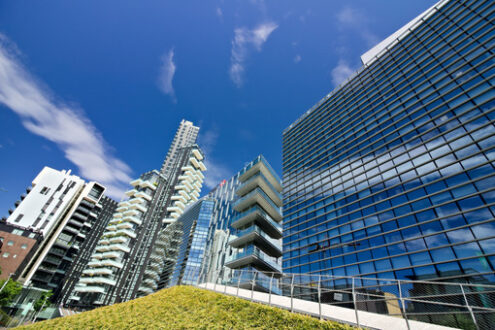 Modern buildings, Milan. Solaria tower with balconies and modern buildings with curtan glass facades.  Business district with skyscrapers and glazed buildings. - MyVideoimage.com | Foto stock & Video footage