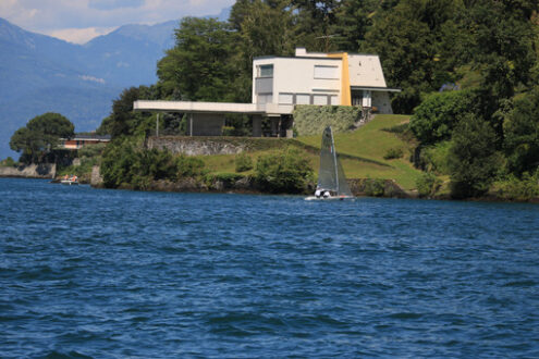 Modern house on the lake shore. A building with a design from th - MyVideoimage.com