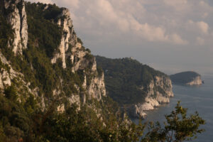 Montagne a picco sul mare. Cinque Terre. Chiesa di Portovenere e le isole Palmaria e Tino. Foto al tramonto. - MyVideoimage.com | Foto stock & Video footage