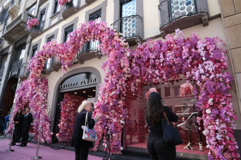 Negozio moda Milano. Facade of the shop with a large bush of rose-colored artificial - MyVideoimage.com | Foto stock & Video footage