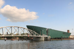 Nemo and steel pedestrian bridge over a canal in Amsterdam. In t - MyVideoimage.com