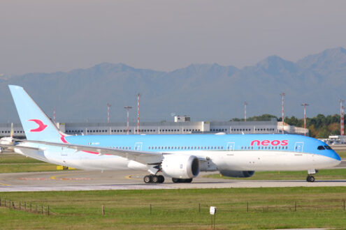 Neos Boeing 787-9 Dreamliner on the Malpensa airport runway. In the background the mountains of the Alps. - MyVideoimage.com