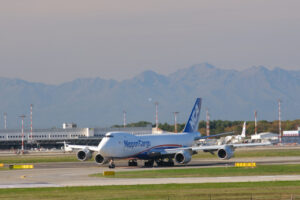 Nippon Cargo Boeing 747 on the Malpensa airport runway.  In the background the mountains of the Alps. - MyVideoimage.com