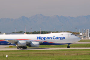 Nippon Cargo Boeing 747 on the Malpensa airport runway.  In the background the mountains of the Alps. - MyVideoimage.com