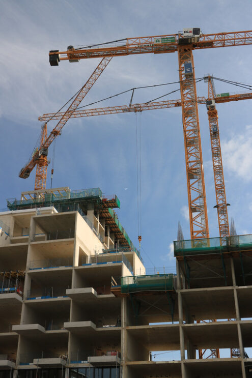 Numerous cranes for lifting materials on a construction site. Stock photo royalty free - MyVideoimage.com | Foto stock & Video footage