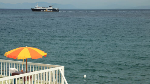 Ombrellone sul mare. Umbrella on a pier with a white parapet on the sea of Ischia. - MyVideoimage.com | Foto stock & Video footage