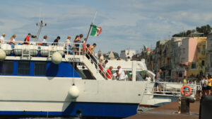 Ormeggio in porto. Small ship strolling at the port of Procida, Naples. Docking stage at the pier. People intent on landing. - MyVideoimage.com | Foto stock & Video footage