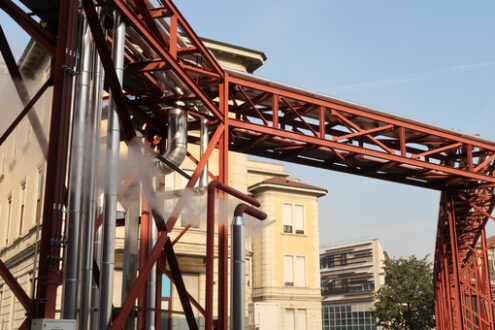 Ospedale Maggiore Milano. Major hospital, polyclinic. Implant piping resting on a steel structure. Fence of the construction site for the construction of the new hospital. - MyVideoimage.com | Foto stock & Video footage