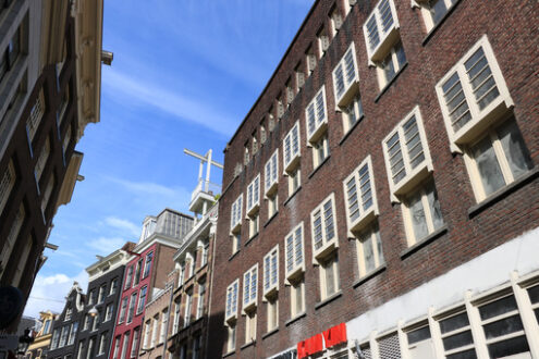 Palaces in a city street with brick wall and white windows. Blue - MyVideoimage.com