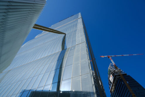 Palazzo in vetro a Milano. Detail of the facade of the Allianz skyscraper by Arata Isozaki. in Milan. Complex of the three towers at Citylife. In the background  Libeskind towe under construction. - MyVideoimage.com | Foto stock & Video footage