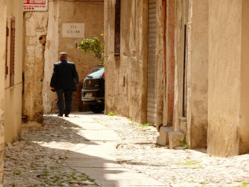 Palermo, Sicily, Italy. A Sicilian walks on a small street - MyVideoimage.com | Foto stock & Video footage