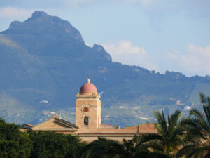 Palermo, Sicily, Italy.  Bell tower and church with mountains background. - MyVideoimage.com