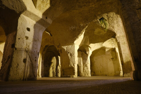 Palombaro di Matera. Cisterne per l’acqua. Sassi of Matera in Italy. Underground entry to the tanks called Palombaro illuminated by the lucenotturna of the sodium lamps. - MyVideoimage.com | Foto stock & Video footage