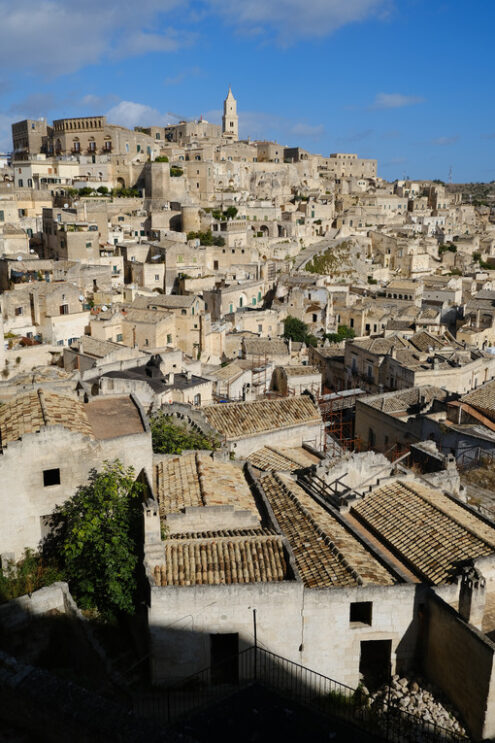 Panorama di Matera in Basilicata. Panorama of houses and of the Sassi of Matera with roofs and streets. Blue sky with - MyVideoimage.com | Foto stock & Video footage