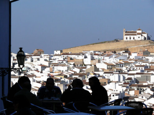 Silhouette of people. Panoramic view of the city of Antequera in Spain.