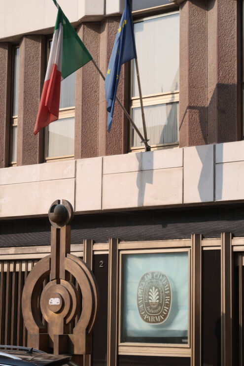 Parma Chamber of Commerce. Palace with bronze sculpture and Italian and Euripean flags. - MyVideoimage.com