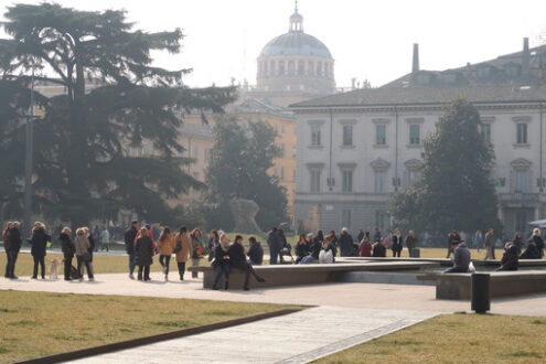 People walking in the winter in the gardens of Piazza della Pace in Parma. - MyVideoimage.com