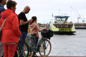 People with bicycles waiting for the ferry. - MyVideoimage.com