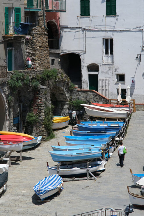 Piazza a Riomaggiore. Dry boats parked in the town square during the coronavirus in the Cinque Terre.  Royalty Free Photos. - MyVideoimage.com | Foto stock & Video footage