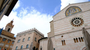 Piazza della Repubblica in Foligno with the town hall and canonics. The ancient palaces lit by the sun with cloudy sky. - MyVideoimage.com