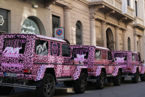 Pink off-road, Via Montenapoleone, Milan. Pink off-road vehicles run along Via Montenapoleone in Milan. Luxury shops and cars in the fashion week. - MyVideoimage.com | Foto stock & Video footage