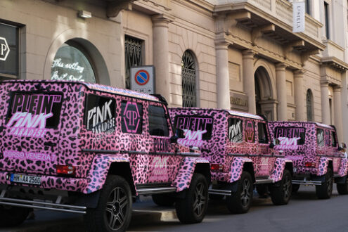 Pink off-road, Via Montenapoleone, Milan. Pink off-road vehicles run along Via Montenapoleone in Milan. Luxury shops and cars in the fashion week. - MyVideoimage.com | Foto stock & Video footage