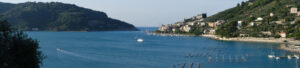 Porto Venere panorama near the Cinque Terre at sunrise light. The bay with the mussel farm, the fort, the church. - MyVideoimage.com | Foto stock & Video footage