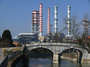 Power plant chimneys and a canal bridge in the foreground. - MyVideoimage.com