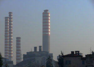 Power plant chimneys shooting at sunset. - MyVideoimage.com